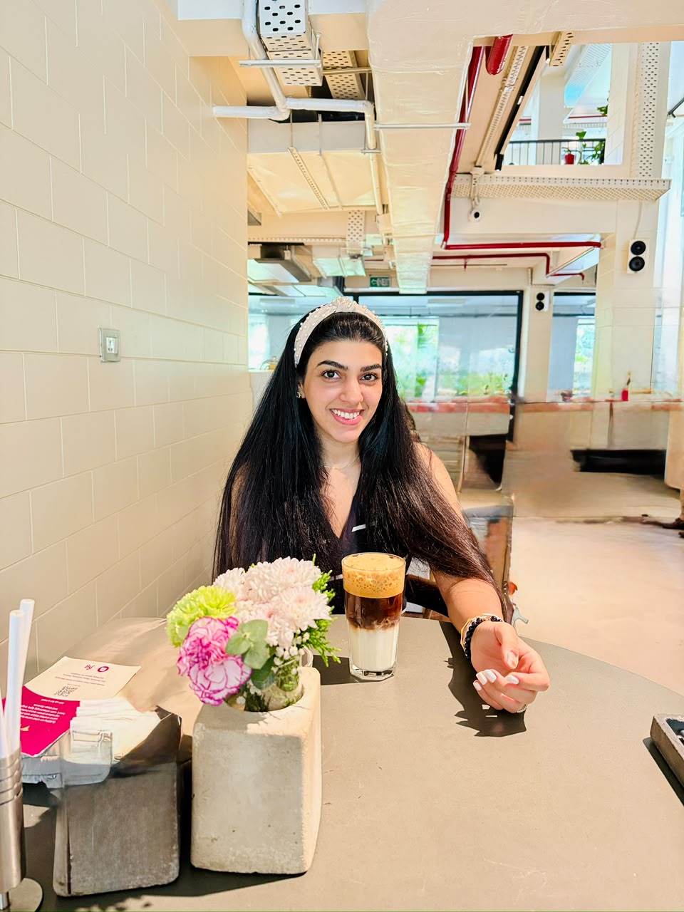 Ambika Setia seated at a café